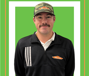 A SERVPRO employee is shown in a black shirt with SERVPRO logo