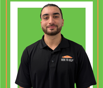 A SERVPRO employee is shown in a SERVPRO polo