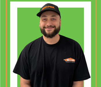 A SERVPRO employee is shown in a black shirt with SERVPRO logo