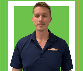 A SERVPRO employee is shown in a black shirt with SERVPRO logo