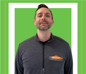 A SERVPRO employee is shown in a black shirt with SERVPRO logo