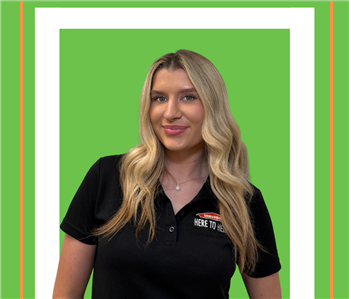 A SERVPRO employee is shown in a black shirt with SERVPRO logo