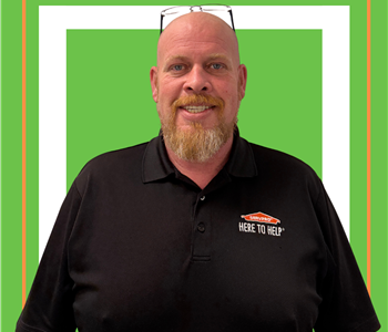 A SERVPRO employee is shown in a black shirt with SERVPRO logo