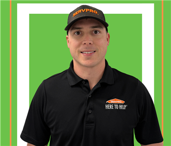 A SERVPRO employee is shown in a black shirt with SERVPRO logo