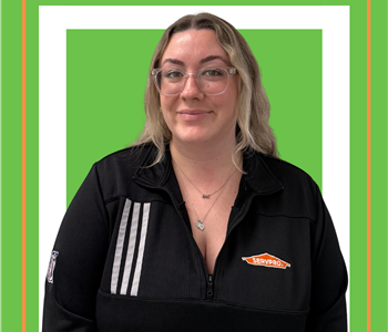 A SERVPRO employee is shown in a black shirt with SERVPRO logo