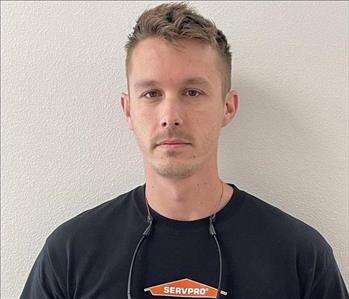 A SERVPRO employee is shown in a black shirt with SERVPRO logo