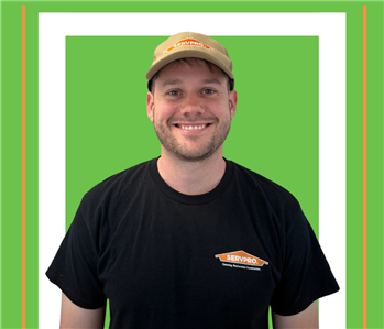 A SERVPRO employee is shown in a black shirt with SERVPRO logo