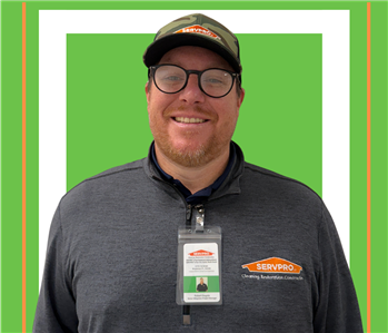 A SERVPRO employee is shown in a black shirt with SERVPRO logo