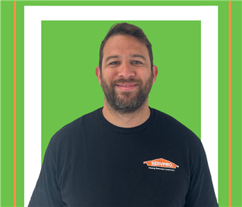 A SERVPRO employee is shown in a black shirt with SERVPRO logo