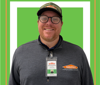 A SERVPRO employee is shown in a black shirt with SERVPRO logo