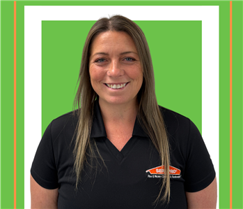 A SERVPRO employee is shown in a black shirt with SERVPRO logo